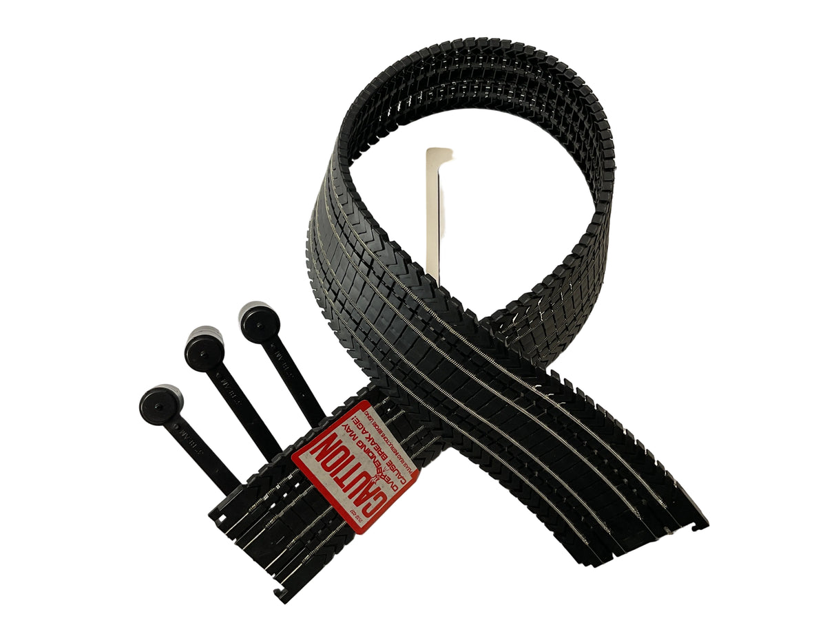 Black flexible track pieces for model trains, coiled and laid out for Aurora Tomy AFX Vintage 2532X
