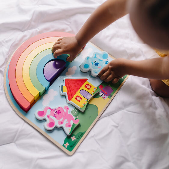Child plays with Blue's Clues wooden rainbow and character puzzle set for Melissa and Doug 33008