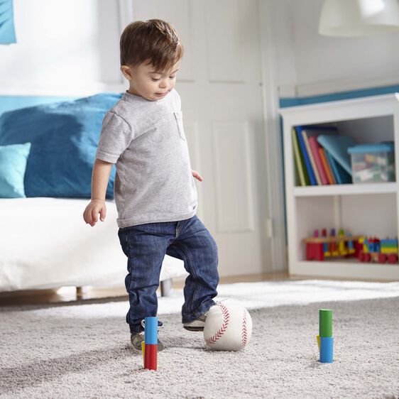 Boy plays with colorful wooden blocks and a baseball on a rug for Melissa and Doug 481