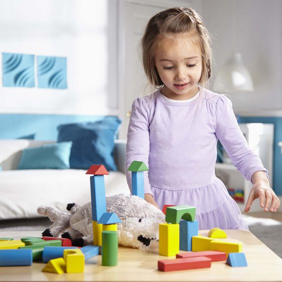 Young girl plays with colorful wooden blocks on a table for Melissa and Doug 481