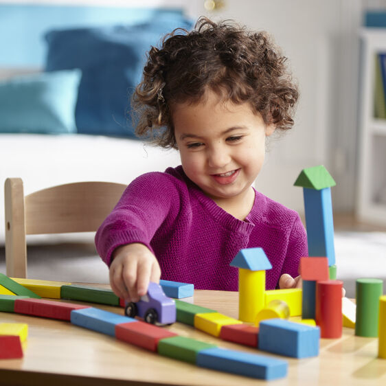 Child plays with colorful wooden blocks on a table for Melissa and Doug 481