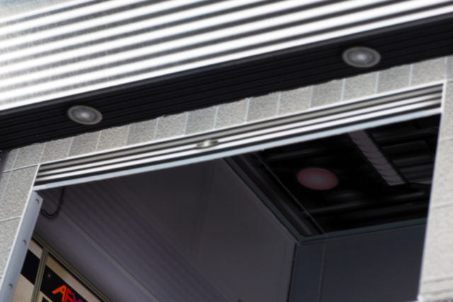 Scale model entrance with overhead lighting fixtures for AFX RaceMaster 1070