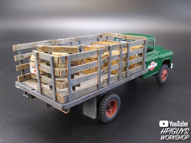 Green stake truck model with stacked wooden crates on a dark surface for Atlantis ALM1401