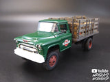 Green 1955 Chevrolet stake truck model kit with a loaded bed for Atlantis ALM1401