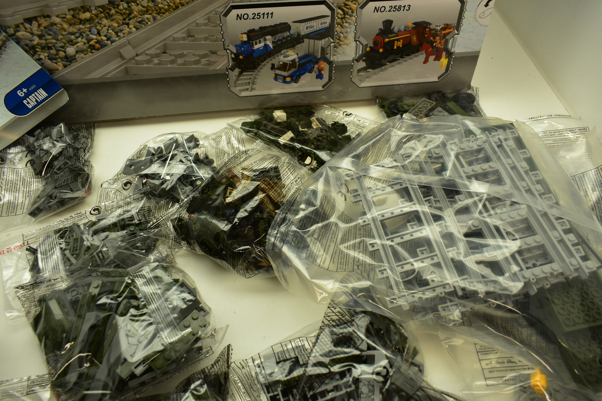 Train set components in clear plastic bags, showing train models and track pieces for Railroad Conveyance Trains AUS25003