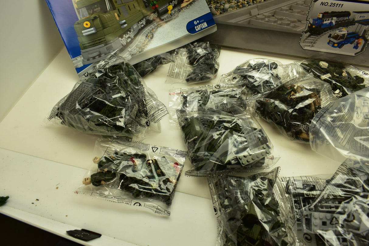 Assortment of train track and train accessory parts in clear bags for Railroad Conveyance Trains AUS25003