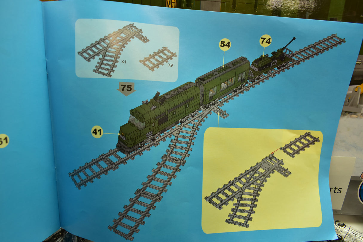 Diagram showing train assembly parts: locomotive, carriages, and track sections for Railroad Conveyance Trains AUS25003