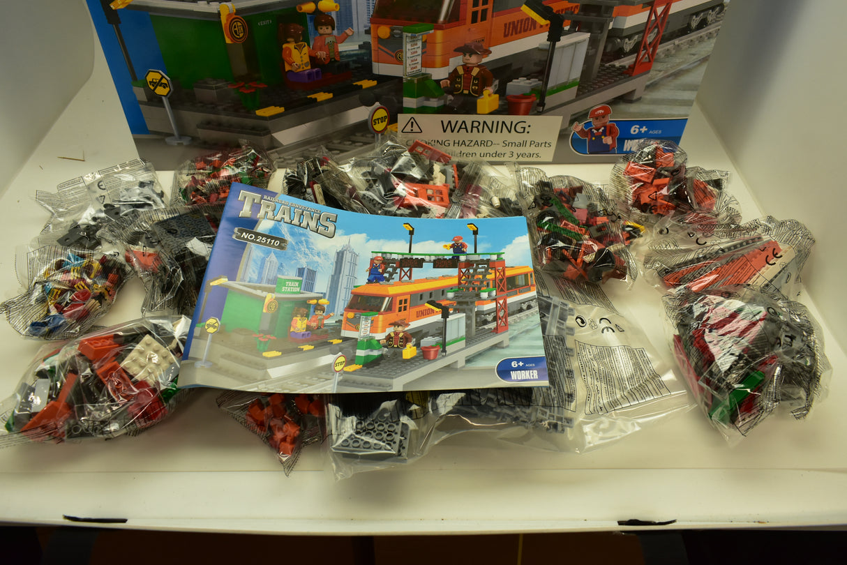Train set with diesel locomotive, passenger cars, and station backdrop for Railroad Conveyance Trains AUS25110