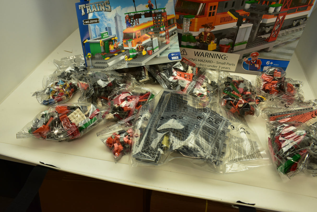 Train set box with orange diesel locomotive and assorted train accessories for Railroad Conveyance Trains AUS25110