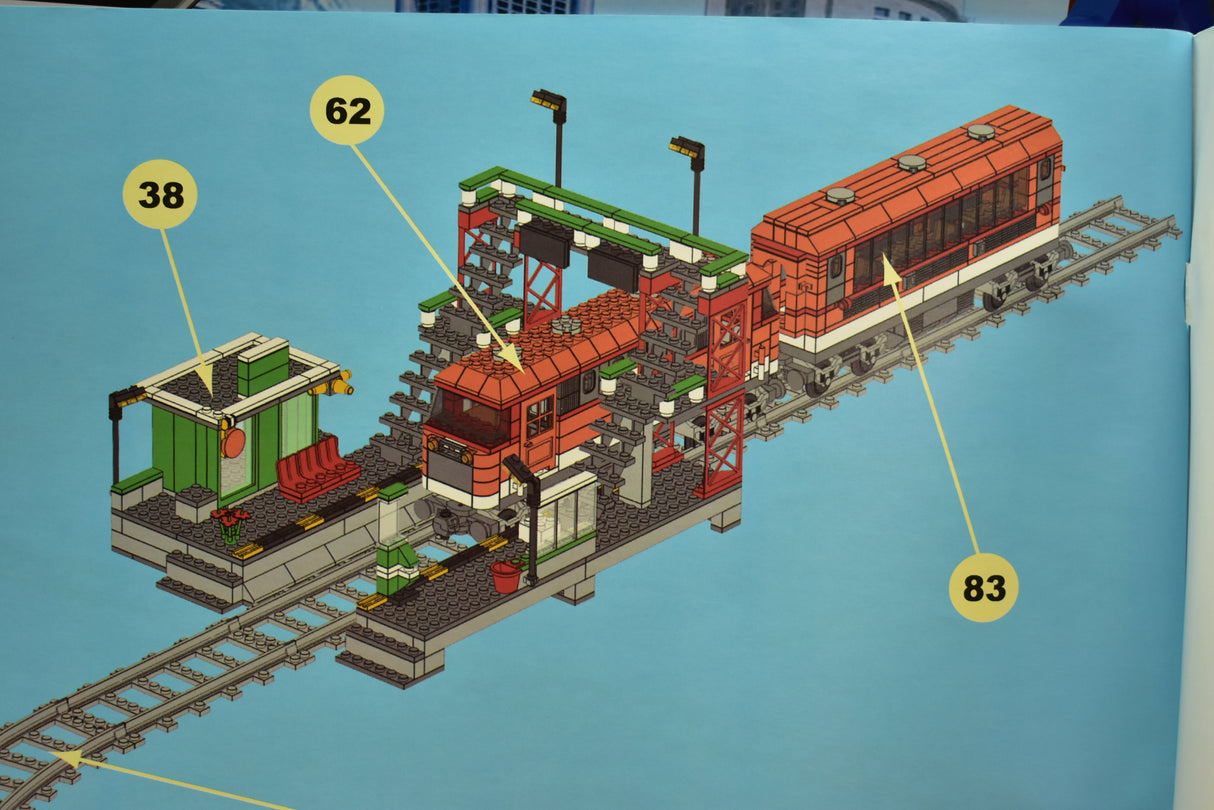 Train set with locomotive, passenger cars, and station platform on tracks for Railroad Conveyance Trains AUS25110, alternate track view