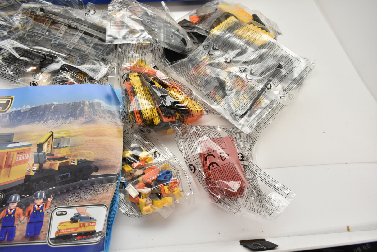 Train toy set components in clear packaging, featuring a diesel switcher for Electric Train AUS25827