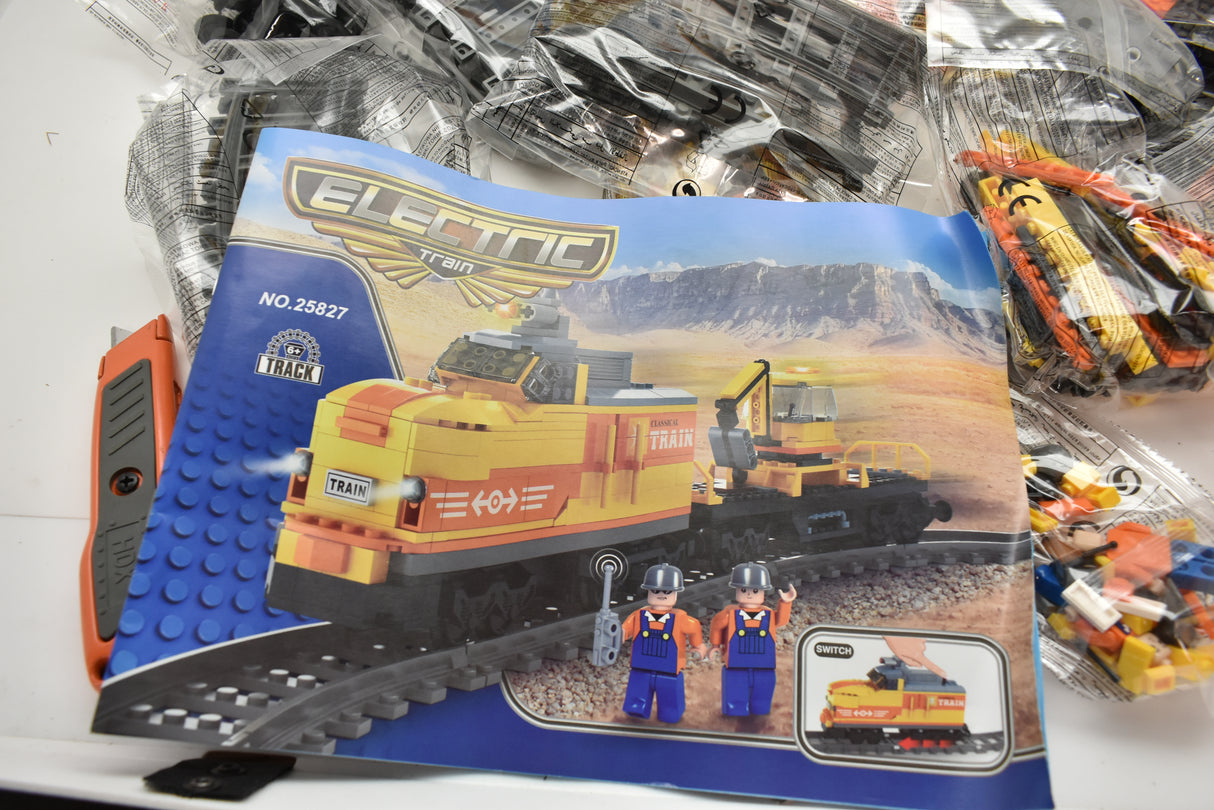 Toy train set box art showing a diesel switcher and flat car on tracks for Electric Train AUS25827