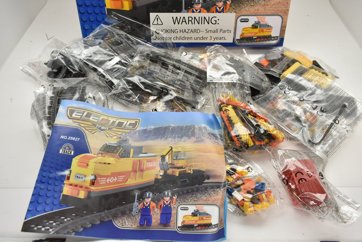 Train set components and box art featuring a yellow diesel switcher locomotive for Electric Train AUS25827