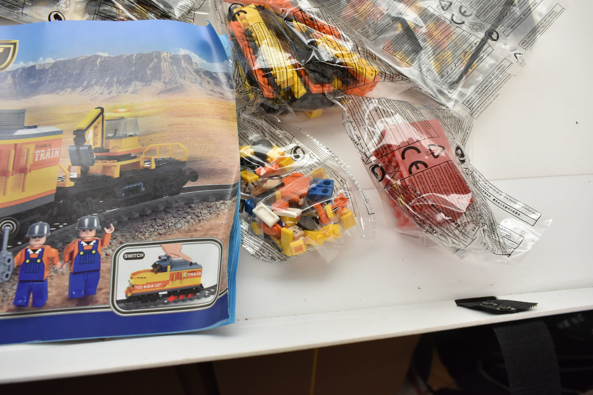 Toy train set featuring a diesel switcher and flat car on a scenic backdrop for Electric Train AUS25827