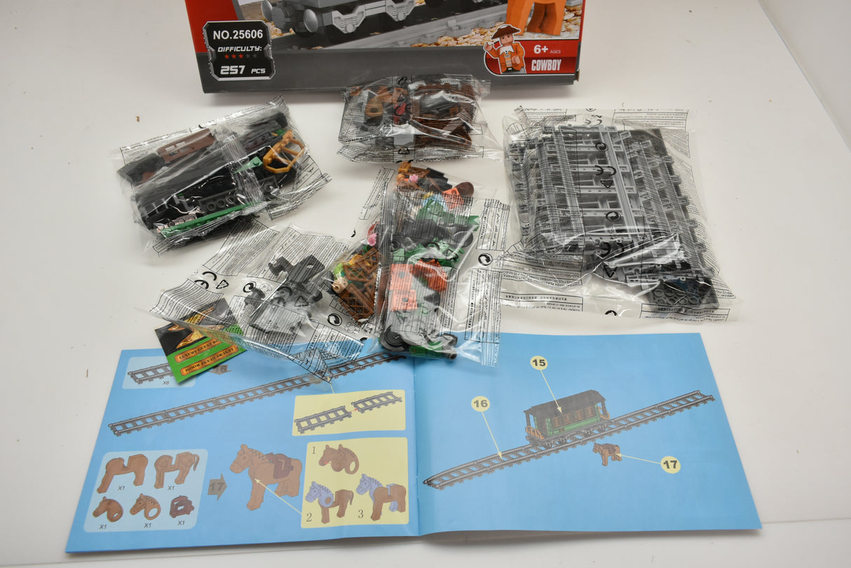 Train track and car components laid out for assembly for Railroad Conveyance Trains AUS25606