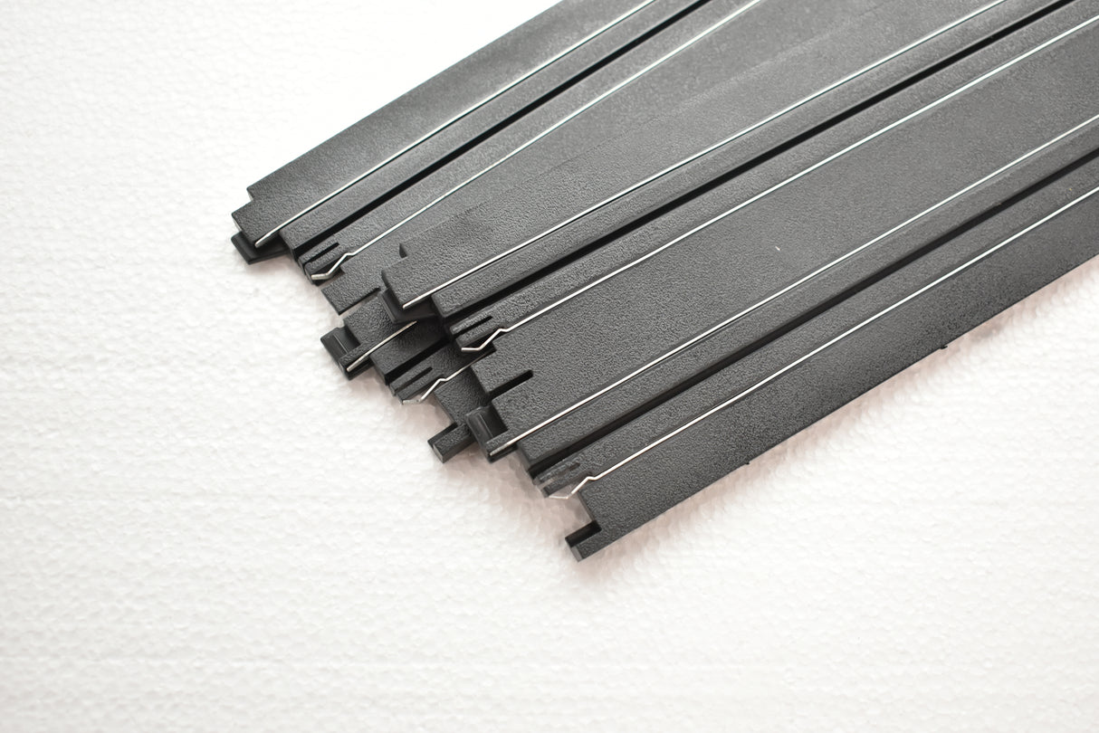 Straight model train track pieces laid out on a white surface for Auto World H0045