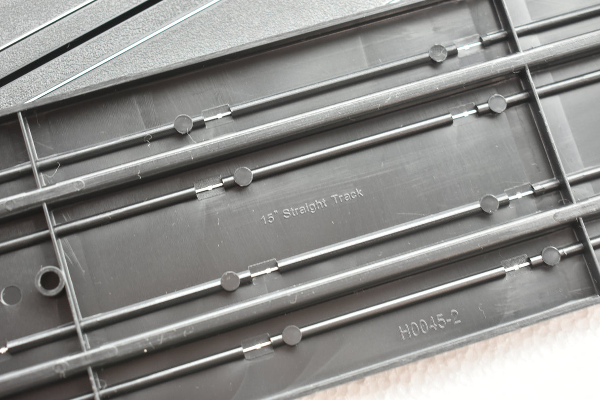 Straight model train track pieces laid out in a row for Auto World H0045