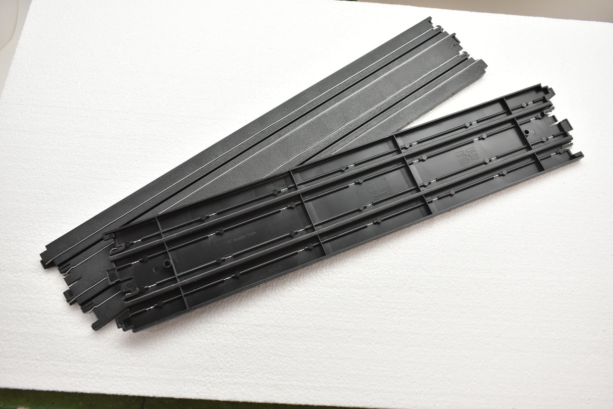 Assortment of black model train straight track pieces for Auto World H0045