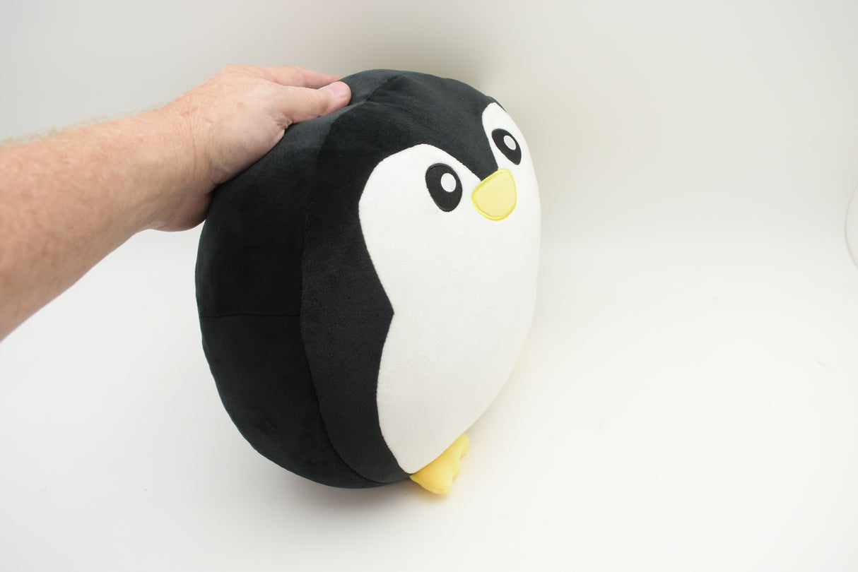 Hand holding a plush toy penguin with black and white coloring for Poptoy 5204P