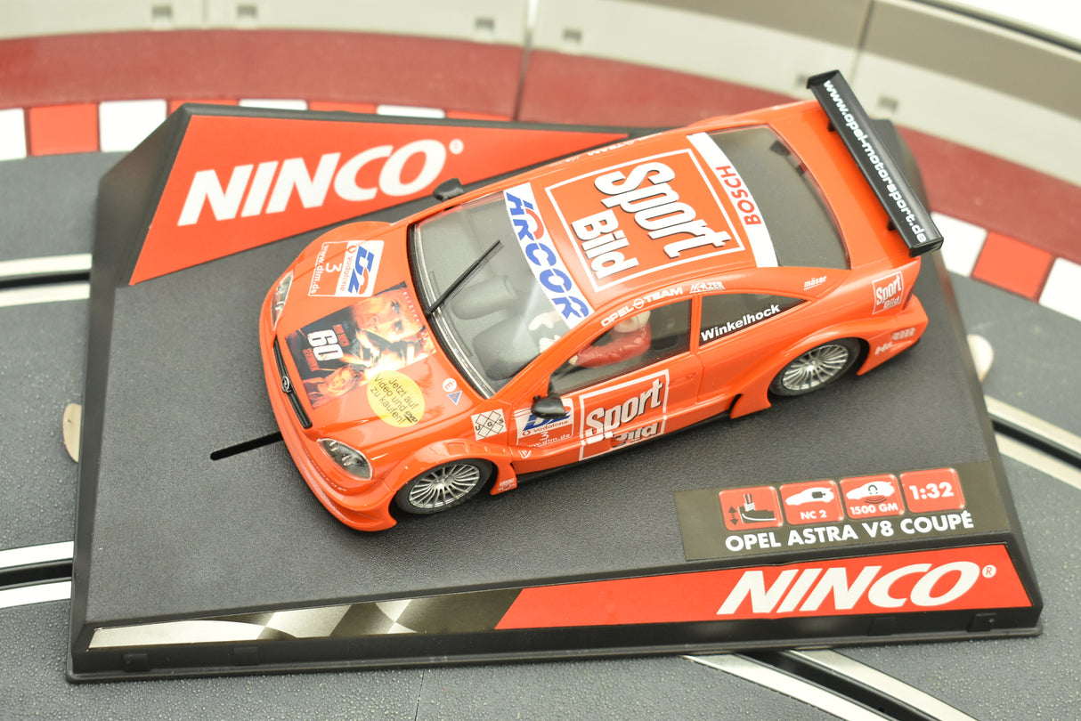 Orange slot car on a black and red baseplate for Ninco 50268