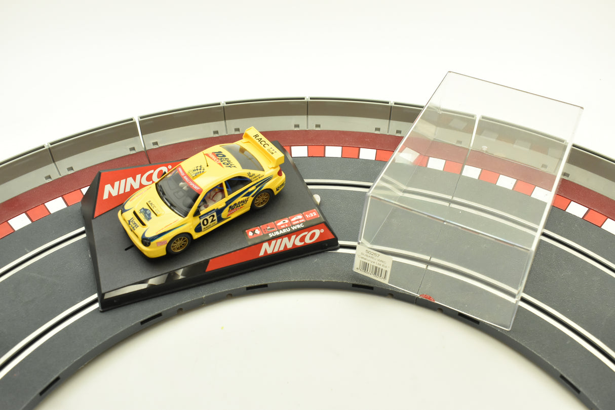Yellow Subaru race car on a track section with "Ninco" branding for 50257