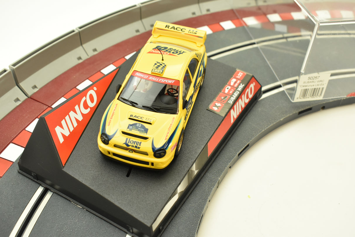 Yellow Subaru rally car on a track section for Ninco 50257