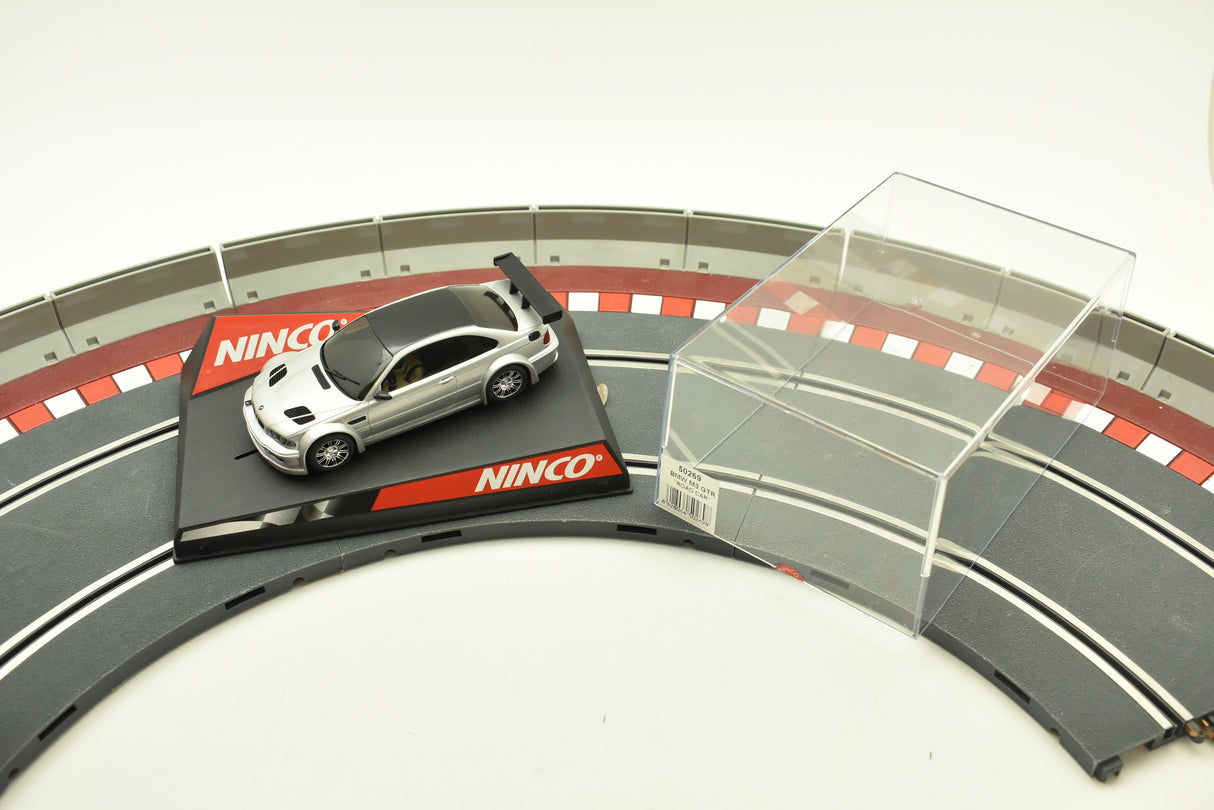 Silver and black BMW M3 GTR race car on a track section for Ninco 50269