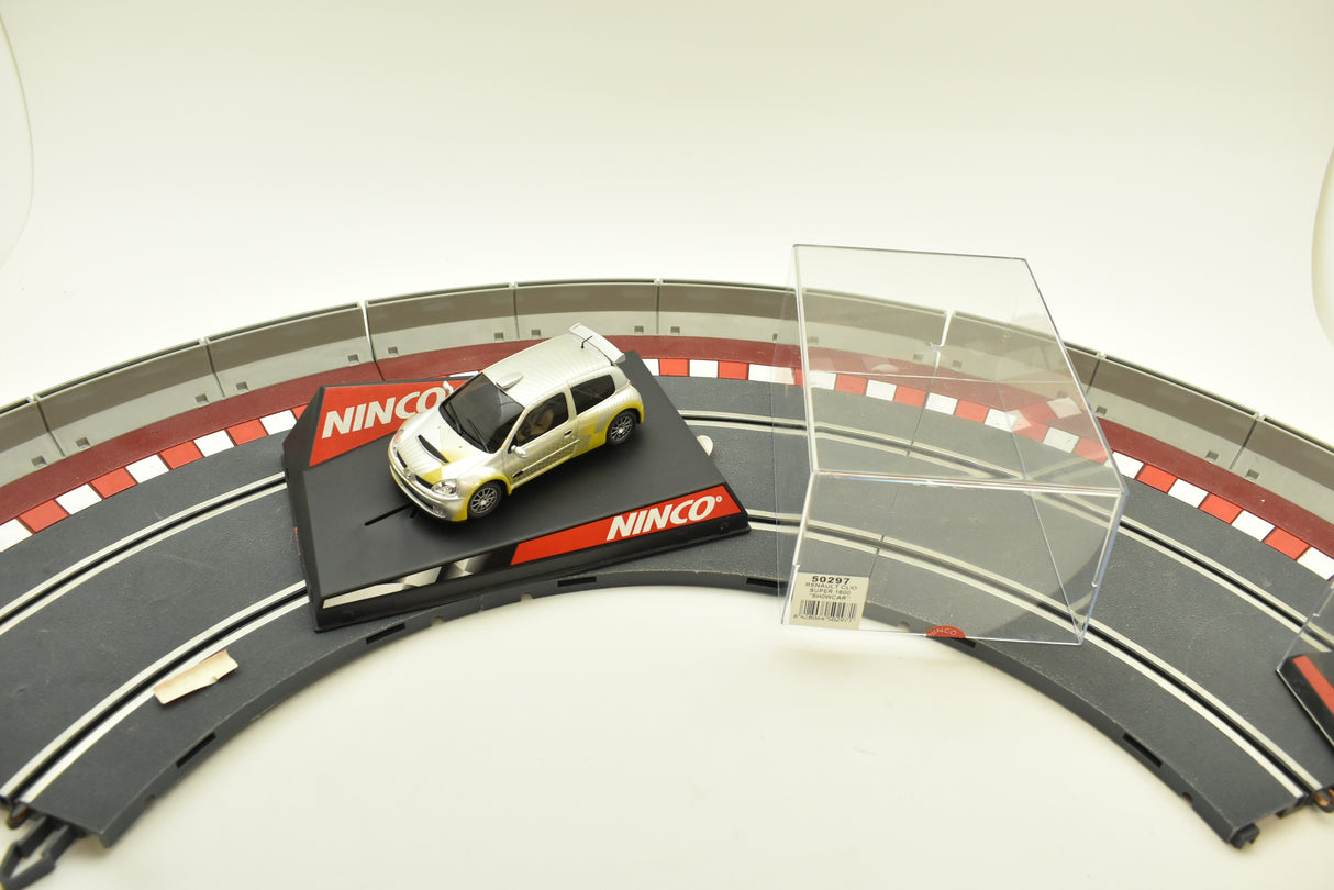 Yellow Renault Clio race car on a track section with display case for Ninco 50297