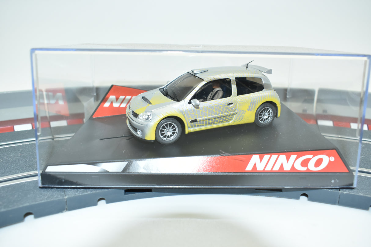 Yellow and grey Renault Clio race car on a display base for Ninco 50297