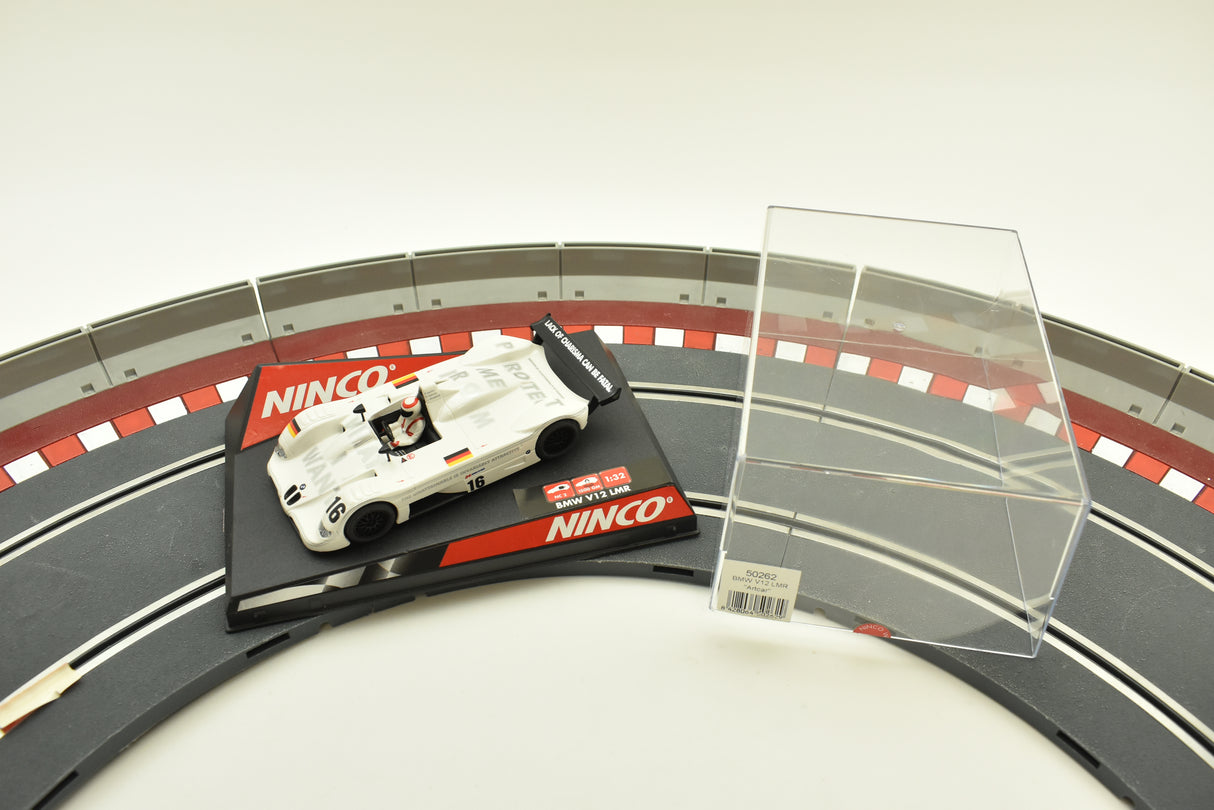 White BMW race car on a track section with clear acrylic stand for REH Ninco 50262
