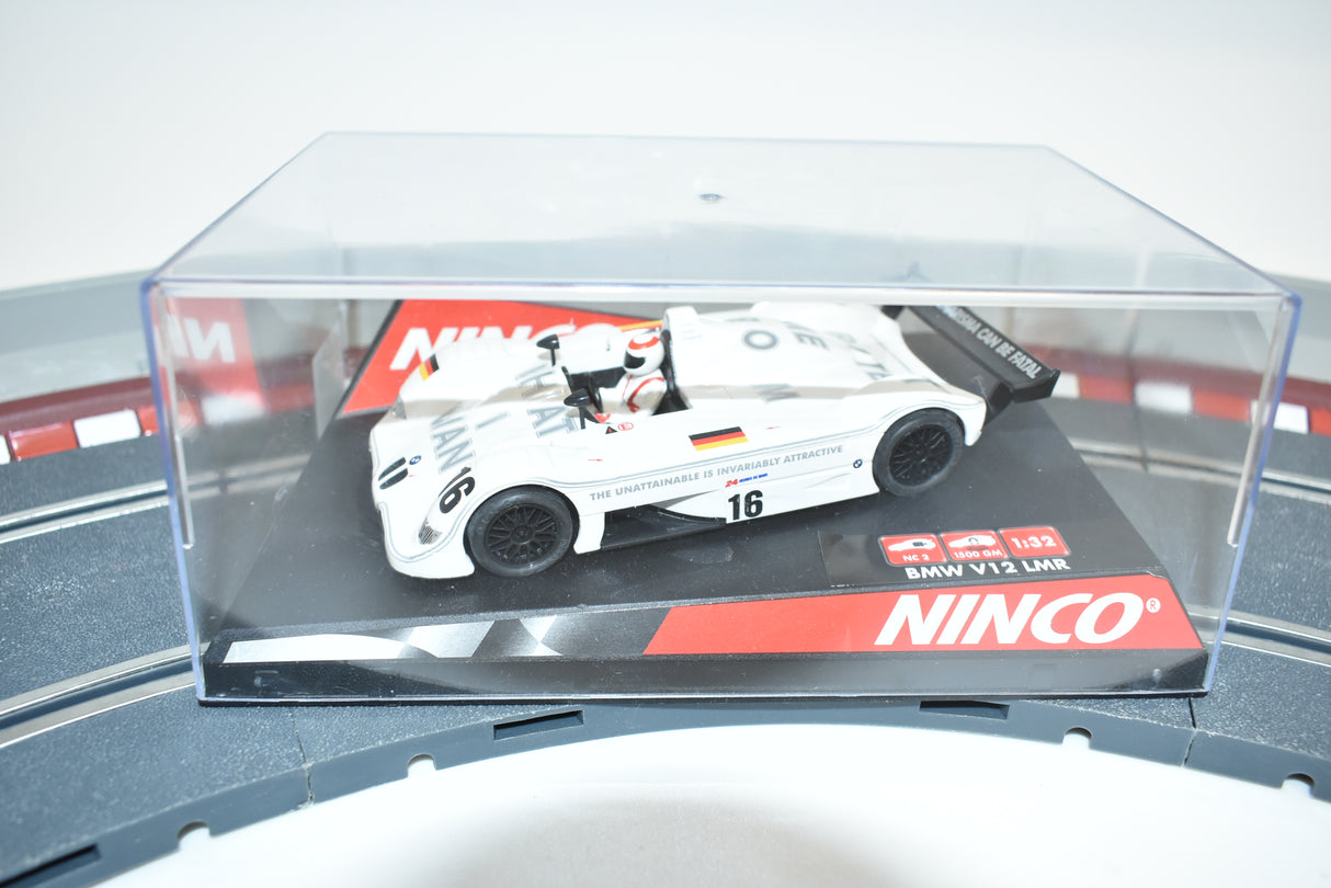 Slot car of a white BMW V12 LMR race car in a clear display case for REH Ninco 50262