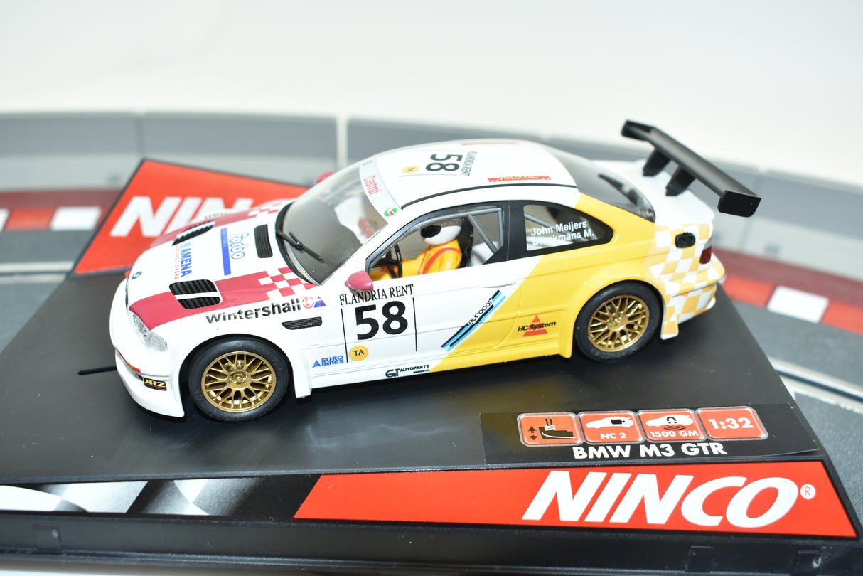 Yellow and white BMW M3 GTR slot car on a track base for REH Ninco 50295