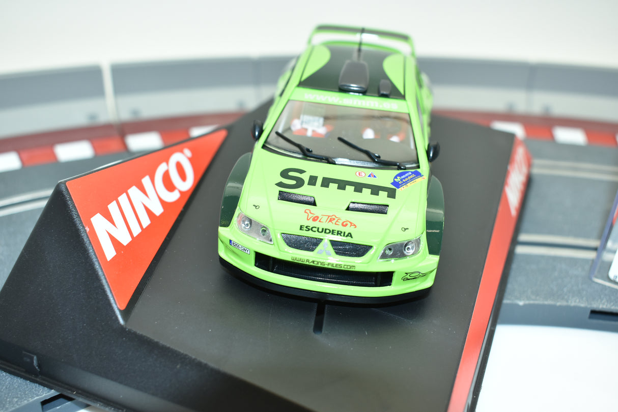Green Mitsubishi Lancer race car on a track base for Ninco 50436