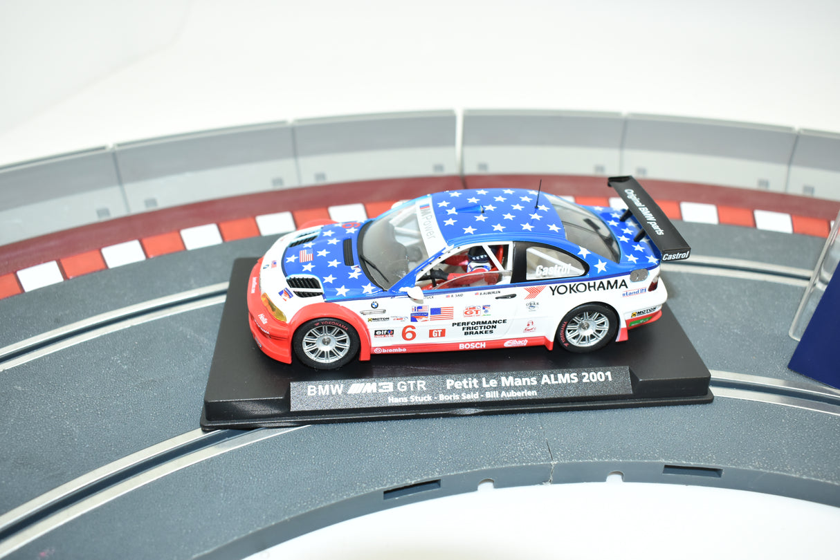 Slot car of a 2001 BMW M3 GTR race car on a track for Fly Car 88049