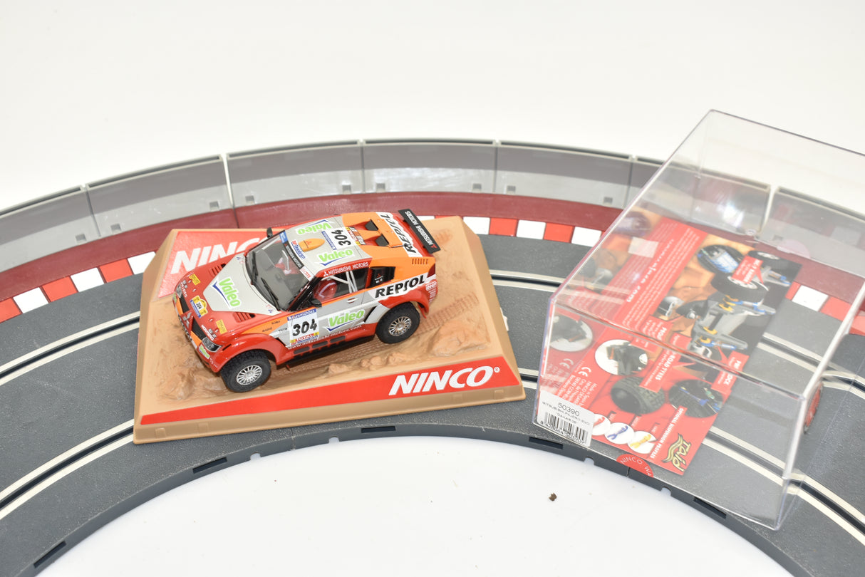 Red Mitsubishi Pajero Evo slot car on display base with packaging for ZZ Expired Kim Collection 50390