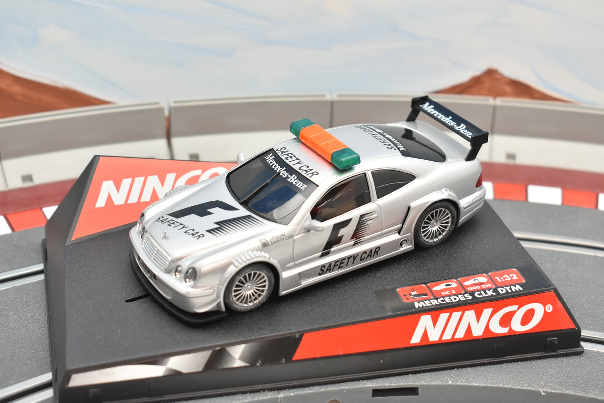 Silver Mercedes-Benz CLK F1 safety car toy on a display base for Ninco 50282