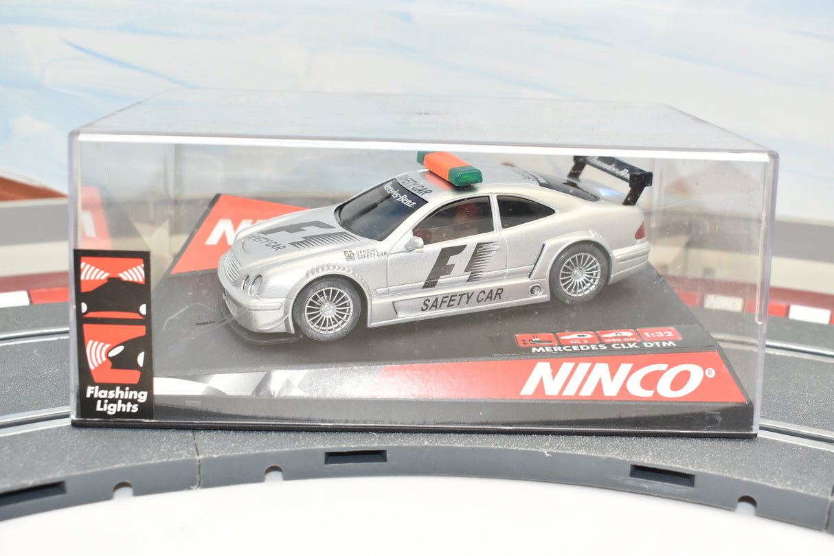 Silver Mercedes CLK safety car toy on a display base for Ninco 50282