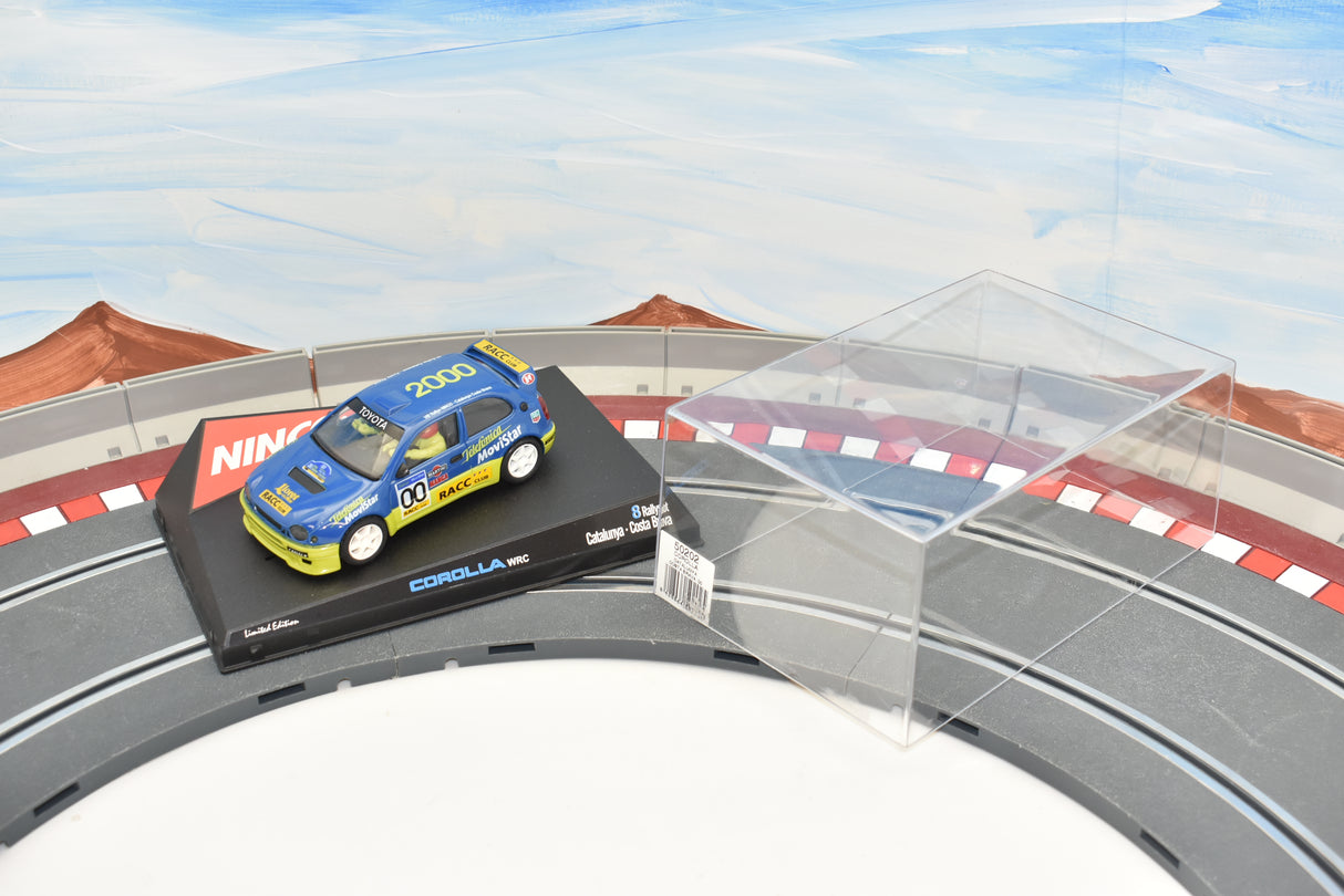 Blue Toyota Corolla race car on a track display with clear acrylic case for Ninco 50202