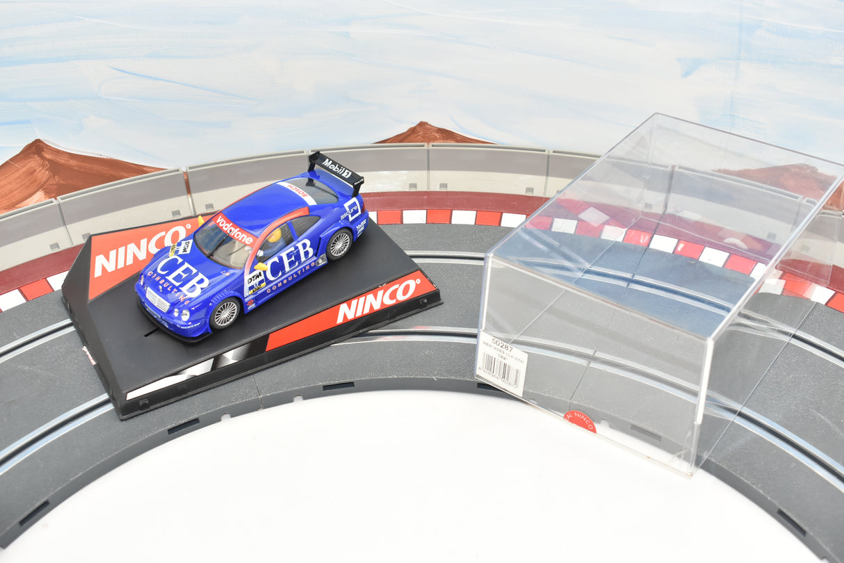 Blue race car on track with clear barrier in foreground for Ninco 50287