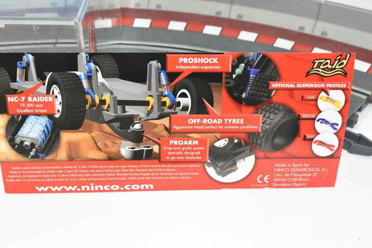 Race car parts display showing suspension, tires, and chassis components for Ninco 50508