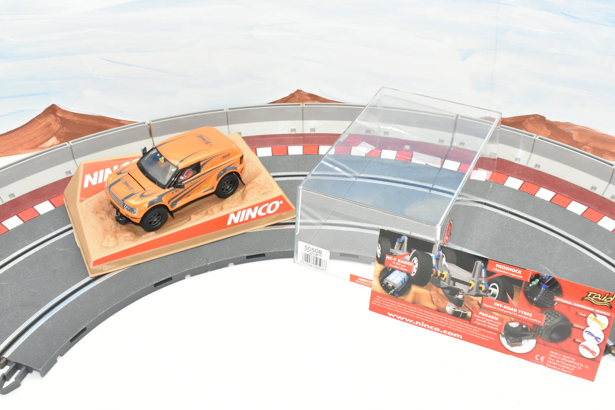Orange race car on track with display case and instructions for Ninco 50508