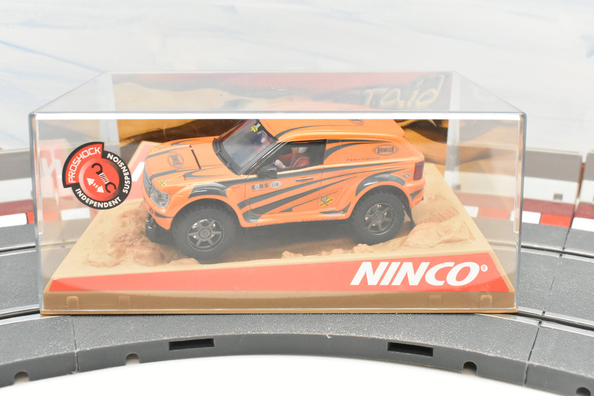 Orange Bowler Nemesis test car in clear display case on track for Ninco 50508