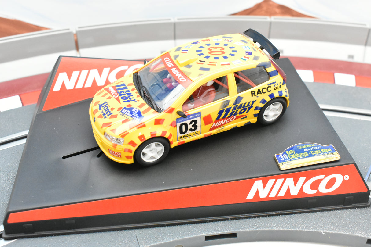 Yellow race car replica on a black and red display base for Ninco 50315