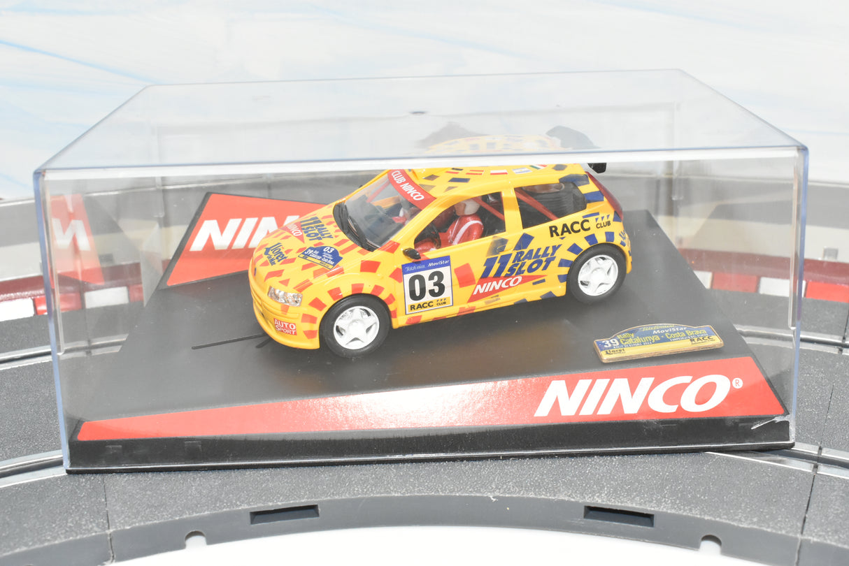 Yellow rally car model on a display base for Ninco 50315