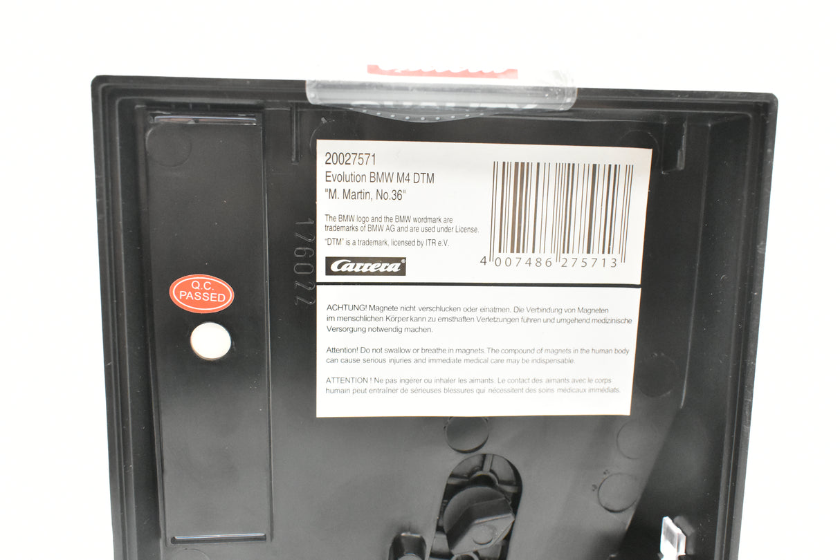 BMW M4 DTM model card with product details and warning labels for Carrera Evolution 27571