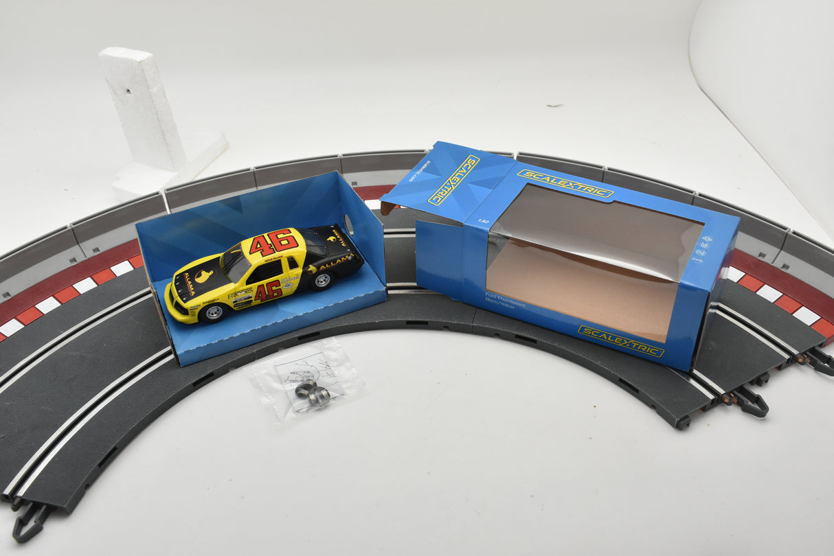 Yellow and black race car on track with open display box for Scalextric C4088