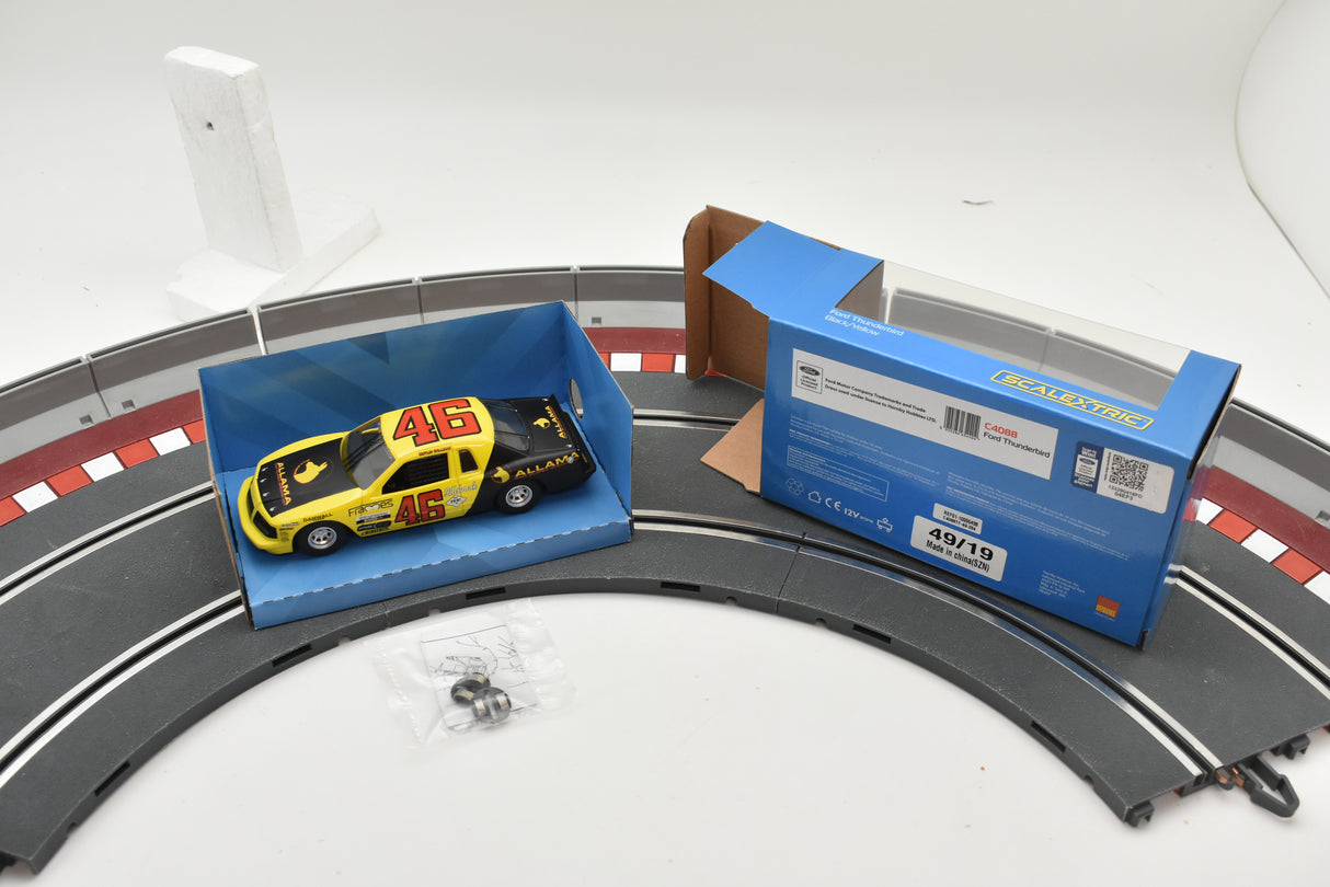 Yellow and black race car model with box and track section for Scalextric C4088