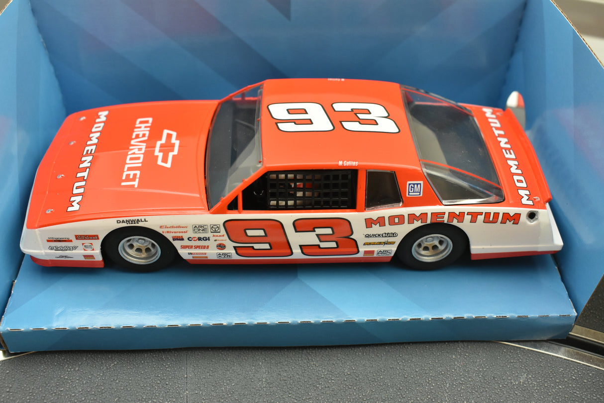 Red Chevrolet Monte Carlo race car model with "MOMENTUM" and "93" decals for Scalextric C3949