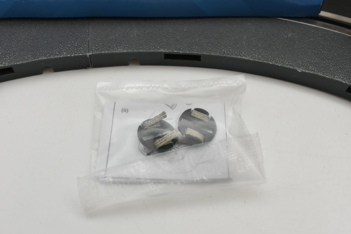 Small bag containing two black, cylindrical parts for model car assembly for Scalextric C3949