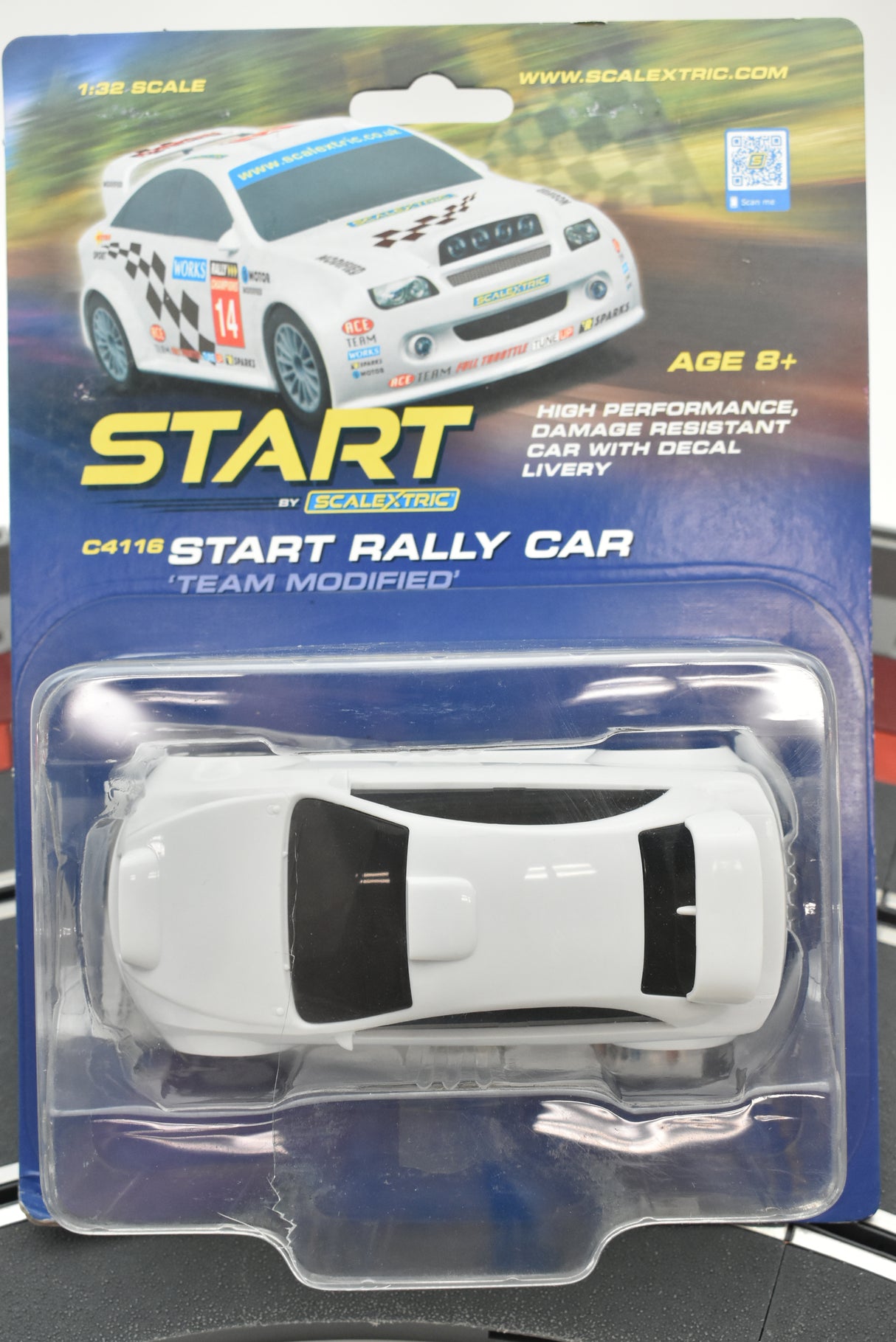 White remote-control rally car in clear plastic packaging for Scalextric C4116